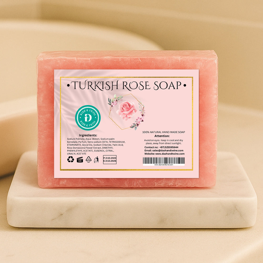 Turkish rose pink handmade soap bar with floral label, wrapped in clear plastic and placed on a white surface